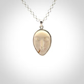 Hand made woolly mammoth tusk moon face necklace. Made by NZ Pacific and sale online only.